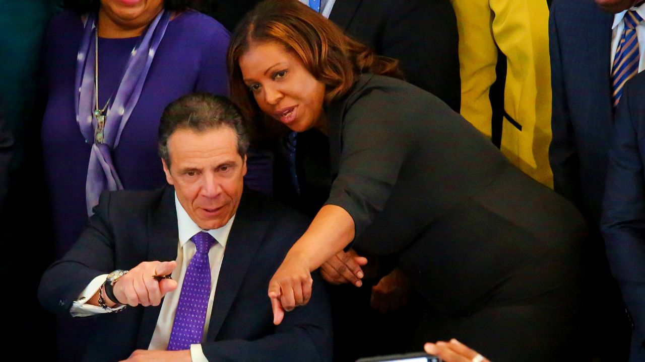 Letitia James speaks with Andrew Cuomo at an event in New York.