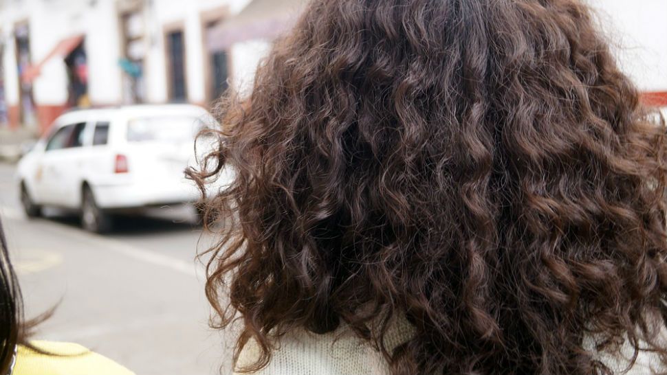 FILE- Back of woman's head facing the street.