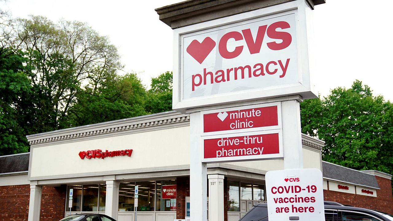Vehicles are parked in front of a CVS Pharmacy in Mount Lebanon, Pa., on Monday May 3, 2021. (AP Photo/Gene J. Puskar)