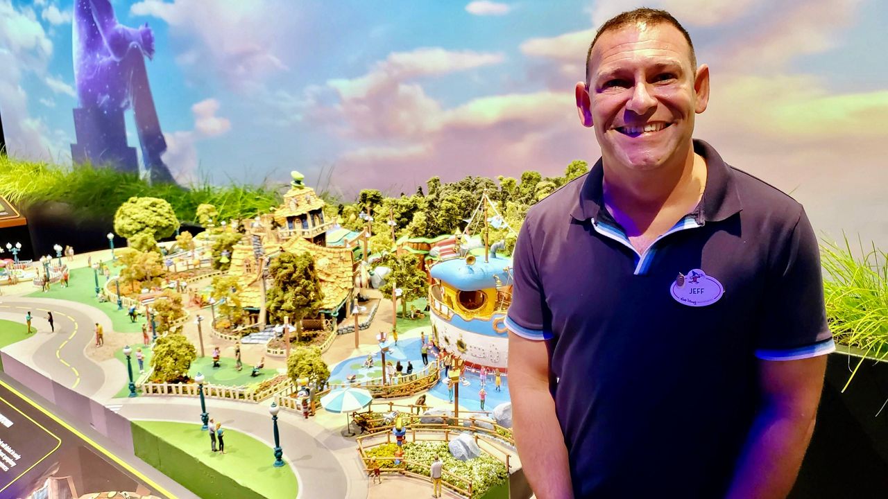 Jeffrey Shaver-Moskowitz, an executive portfolio producer at Disneyland Resort, stands in front of a scale model of Toontown at the D23 Expo in Anaheim (Spectrum News/Joseph Pimentel)