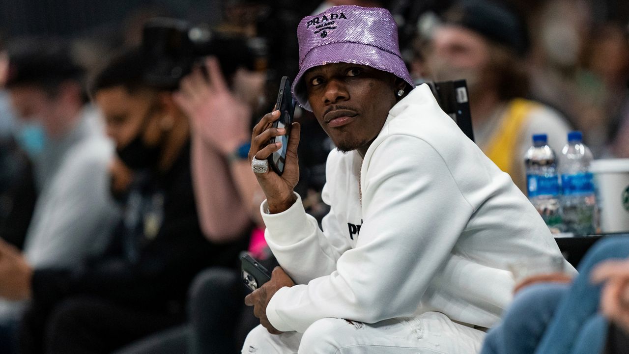 DaBaby looks on during the second half of an NBA basketball game between the Charlotte Hornets and the Los Angeles Lakers in Charlotte, N.C., Friday, Jan. 28, 2022. (AP Photo/Jacob Kupferman)