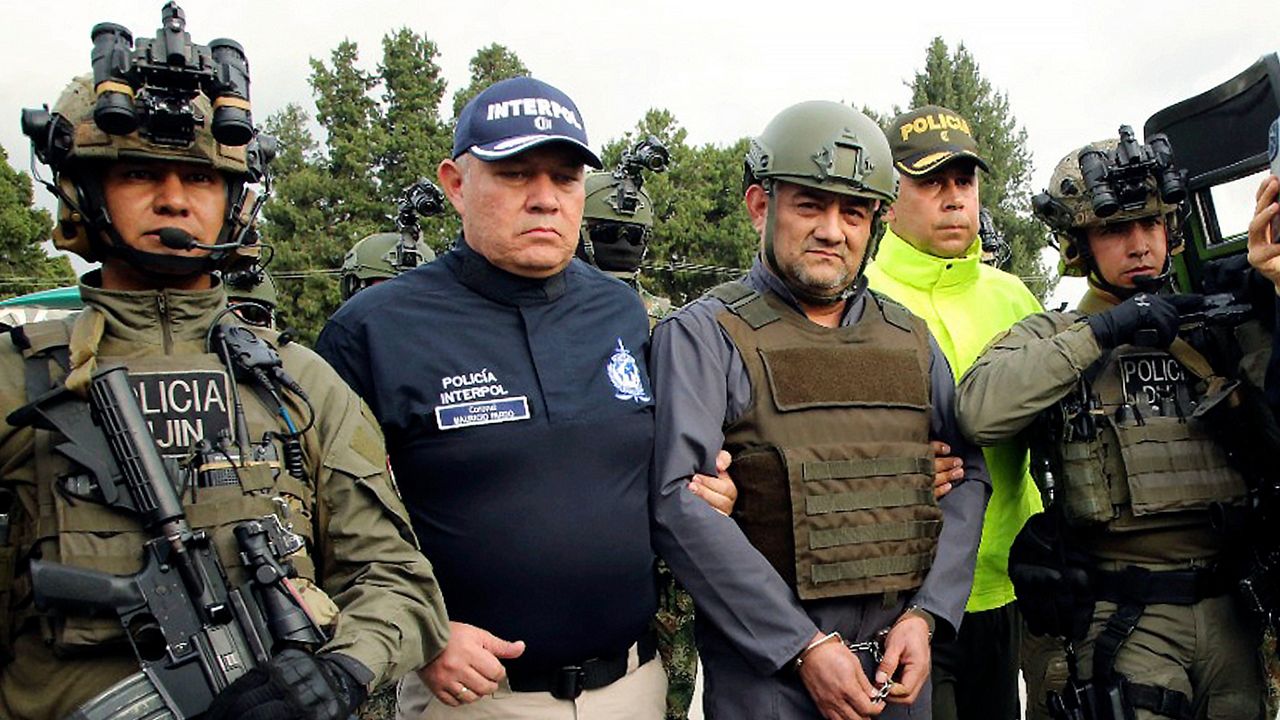 Police escort Dairo Antonio Usuga at a military airport in Bogota, Colombia in 2022.