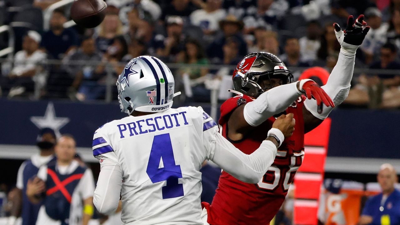 Dallas Cowboys quarterback Dak Prescott (4) is hit by Tampa Bay Buccaneers linebacker Shaquil Barrett (58) while throwing a pass in the second half of a NFL football game in Arlington, Texas, Sunday, Sept. 11, 2022. (AP Photo/Michael Ainsworth)