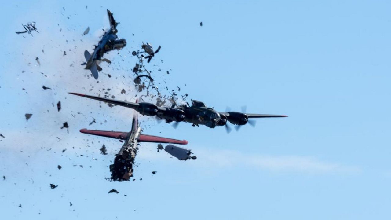 In this photo provided by Larry Petterborg, a Boeing B-17 Flying Fortress and a Bell P-63 Kingcobra collide in the midair during an airshow at Dallas Executive Airport in Dallas, Saturday, Nov. 12, 2022. (Larry Petterborg via AP)