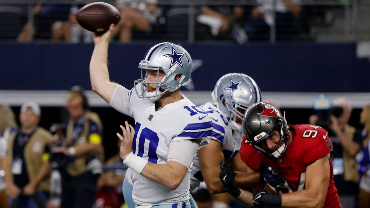 Dallas Cowboys quarterback Cooper Rush (10) throws a pass under pressure from Tampa Bay Buccaneers linebacker Carl Nassib (94) during the second half of an NFL football game in Arlington, Texas, Sept. 11, 2022. The Cowboys are looking for Rush to win the same way he did a year ago in Minnesota, starting Sunday against defending AFC champion Cincinnati after Dak Prescott fractured a bone near his right thumb in a season-opening loss to Tampa Bay. (AP Photo/Michael Ainsworth)