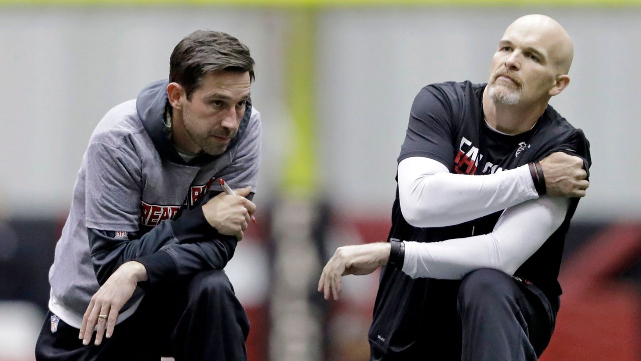 FILE - Atlanta Falcons head coach Dan Quinn, right, talks with offensive coordinator Kyle Shanahan during a workout at the NFL football team's practice facility in Flowery Branch, Ga., Friday, Jan. 27, 2017. Kyle Shanahan and Dan Quinn will always share the painful memory of coaching in the Super Bowl together with Atlanta five years ago when the Falcons couldn't hold a 25-point lead in the second half of a loss to New England. The wild-card meeting Sunday, Jan. 16, 2022 between the visiting 49ers (10-7) and Cowboys (12-5) is the first in the playoffs involving both coaches since that crushing loss in Houston.(AP Photo/David Goldman, File)