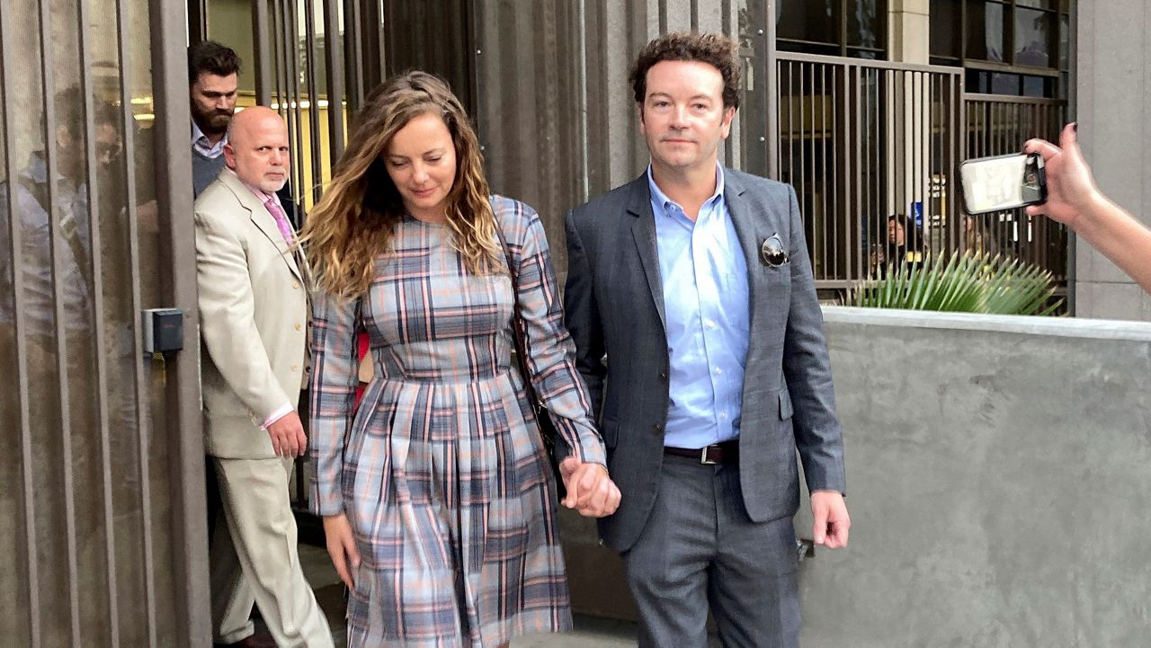 Actor Danny Masterson leaves Los Angeles superior Court with his wife Bijou Phillips after a judge declared a mistrial in his rape case in Los Angeles on Nov. 30, 2022. (AP Photo/Brian Melley, File)