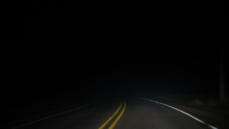 FILE- Dark road.