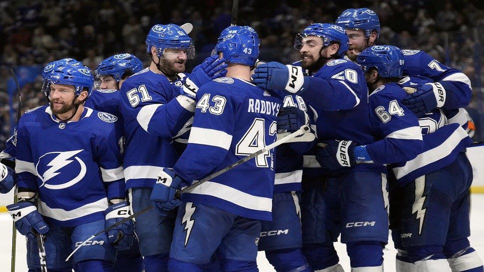 Tampa Bay Lightning defenseman Darren Raddysh (43) celebrates with teammates after scoring the game-winning goal against the New Jersey Devils during overtime in an NHL hockey game Thursday, Jan. 11, 2024, in Tampa, Fla. (AP Photo/Chris O'Meara)