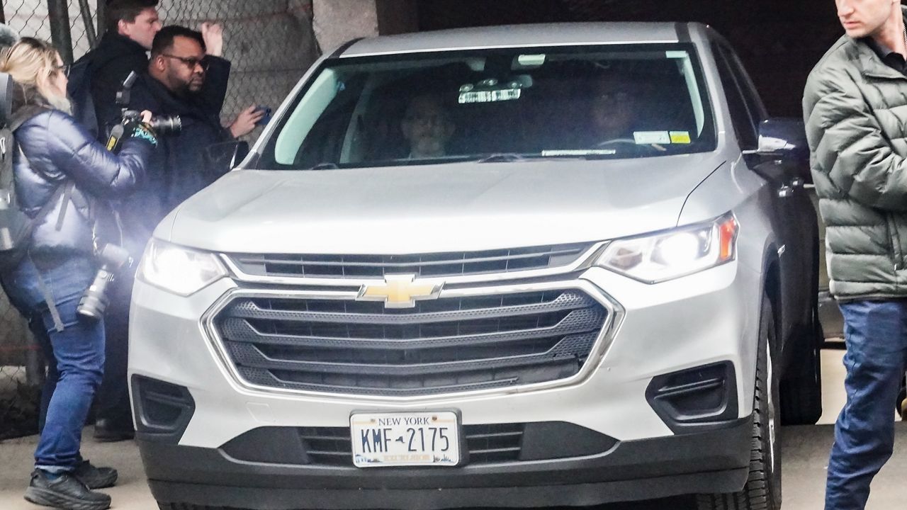 A vehicle leaves the garage at the state office building after David Pecker, former CEO of National Enquirer parent company, was believed to have met with a grand jury convening for the investigation of former President Donald Trump, Monday March 27, 2023, in New York. (AP Photo/Bebeto Matthews)