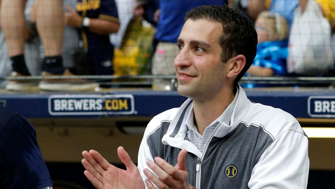 David Stearns claps from the dugout after a baseball game against the New York Mets on Sunday, Sept. 26, 2021 in Milwaukee. (AP Photo/Aaron Gash)