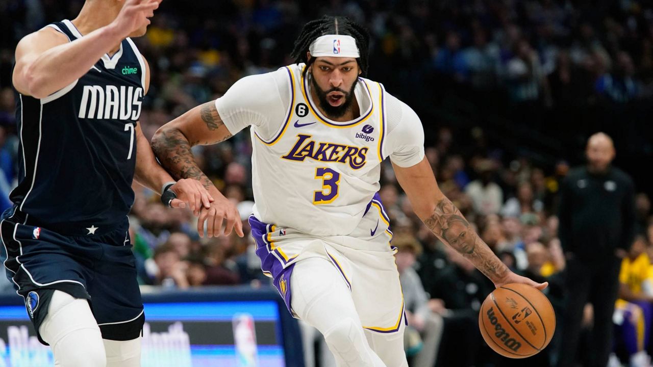 Los Angeles Lakers forward Anthony Davis (3) dribbles against Dallas Mavericks center Dwight Powell (7) during the first half of an NBA basketball game in Dallas on Sunday. (AP Photo/LM Otero)