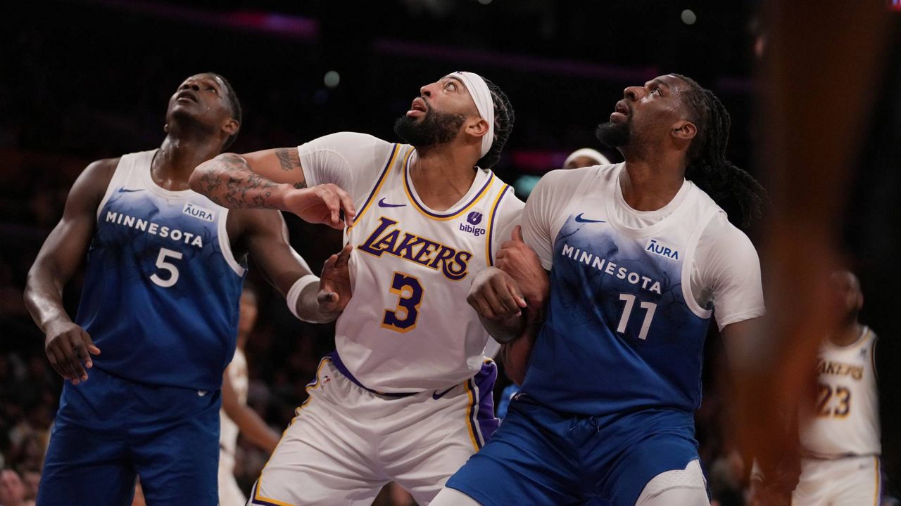 Minnesota Timberwolves guard Anthony Edwards (5), Los Angeles Lakers forward Anthony Davis (3) and Timberwolves center Naz Reid (11) wait for a rebound during the first half of an NBA basketball game in LA on Sunday. (AP Photo/Eric Thayer)
