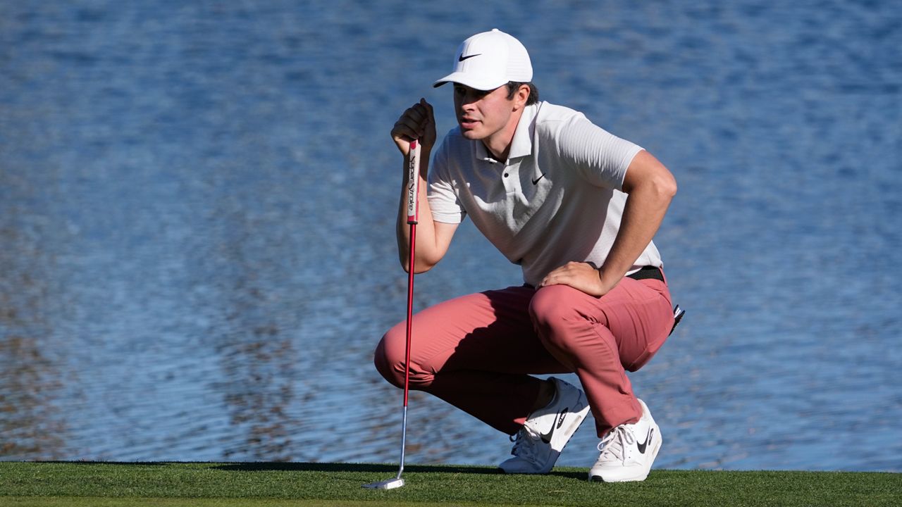 Davis Thompson measures his putt on the ninth green during the American Express golf tournament on the Nicklaus Tournament Course at PGA West Friday, Jan. 20, 2023, in La Quinta, Calif. (AP Photo/Mark J. Terrill)