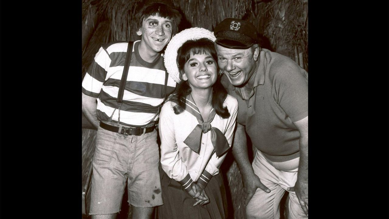 Bob Denver, Dawn Wells, and Alan Hale Jr. (l-r), cast members of tv series "Gilligan's Island", B&W photo on black