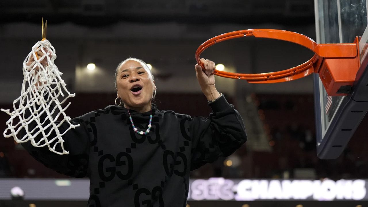 South Carolina head coach Dawn Staley celebrates cutting the net after their win against LSU in an NCAA college basketball game at the Southeastern Conference women's tournament final Sunday, March 10, 2024, in Greenville, S.C. (AP Photo/Chris Carlson)