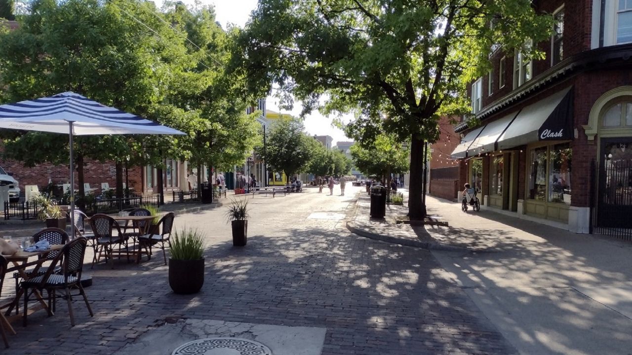 People walk down a pedestrian and bicycle-friendly corridor of Fifth Street in downtown Dayton. (Photo courtesy of City of Dayton)