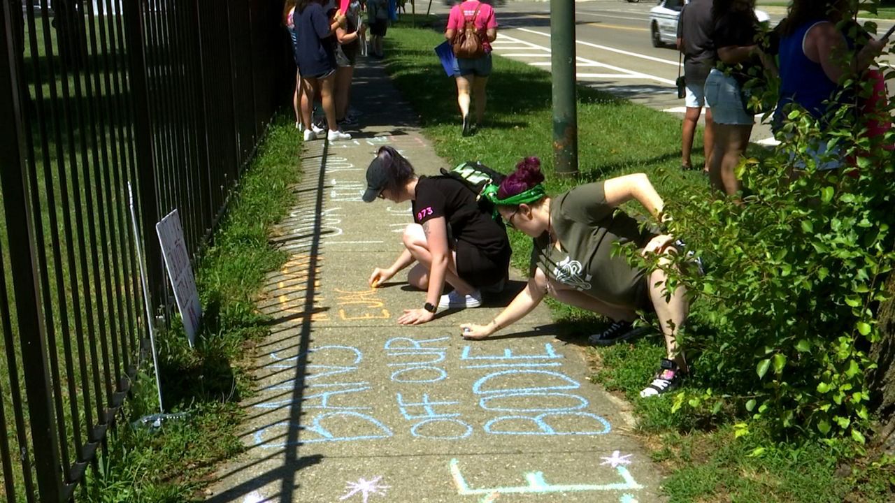 FILE PHOTO: Abortion rights protesters in Dayton, Ohio, write messages on the sidewalk. (Spectrum News)