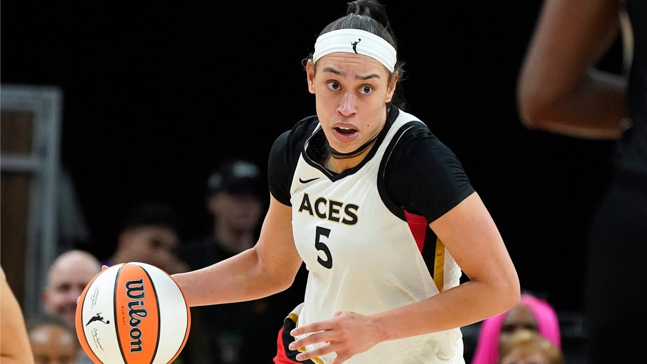 Las Vegas Aces' Dearica Hamby (5) dribbles up court during a WNBA basketball game against the Phoenix Mercury, on May 6, 2022, in Phoenix. (AP Photo/Darryl Webb, File)