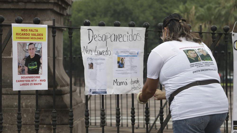 Family of Ricardo Valdes, who disappeared on the road on May 25, placed missing posters during a protest in Monterrey, Nuevo Leon state, Mexico, Thursday, June 24, 2021. (AP Photo/Roberto Martinez)