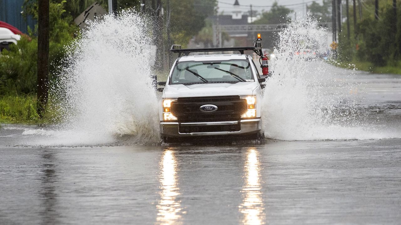 A truck sprays flood water