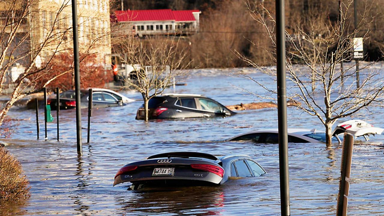 Cars are flooded in a parking lot at the Hathaway Creative Center alongside the Kennebec River, Tuesday, Dec. 19, 2023, in Waterville, following a severe storm. (Associated Press/Robert F. Bukaty, File)