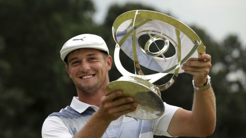 Bryson DeChambeau holds up the trophy after winning the Northern Trust golf tournament, Sunday, Aug. 26, 2018, in Paramus, N.J. (AP Photo/Mel Evans)