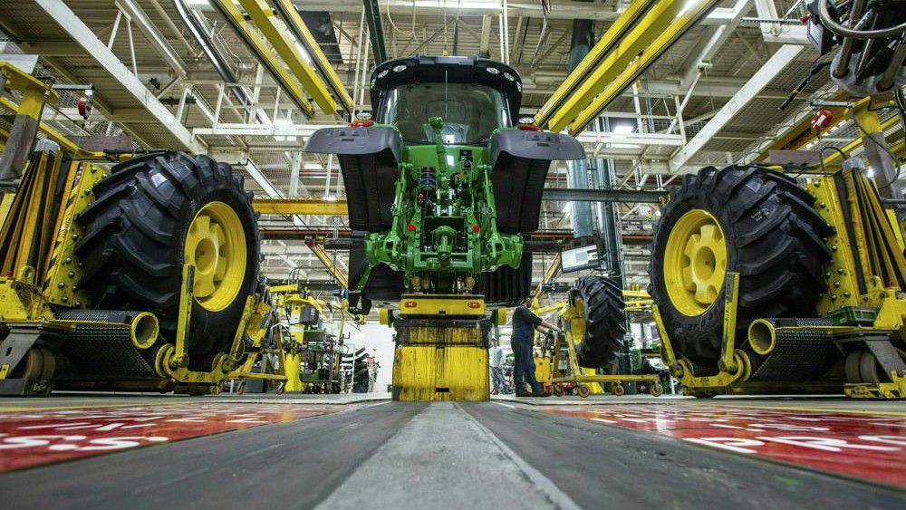 In this April 9, 2019, wheels are attach as workers assemble a tractor at John Deere's Waterloo, Iowa assembly plant.  (Zach Boyden-Holmes/Telegraph Herald via AP, File)
