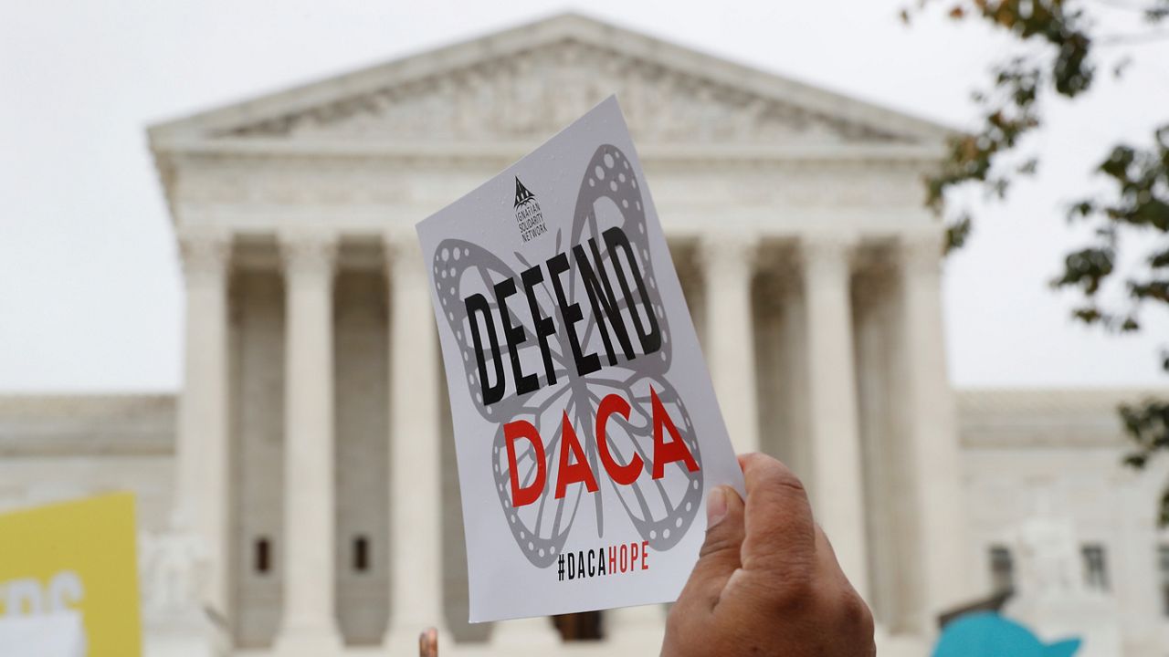 A protester holds up a "Defend DACA" sign. (Associated Press)