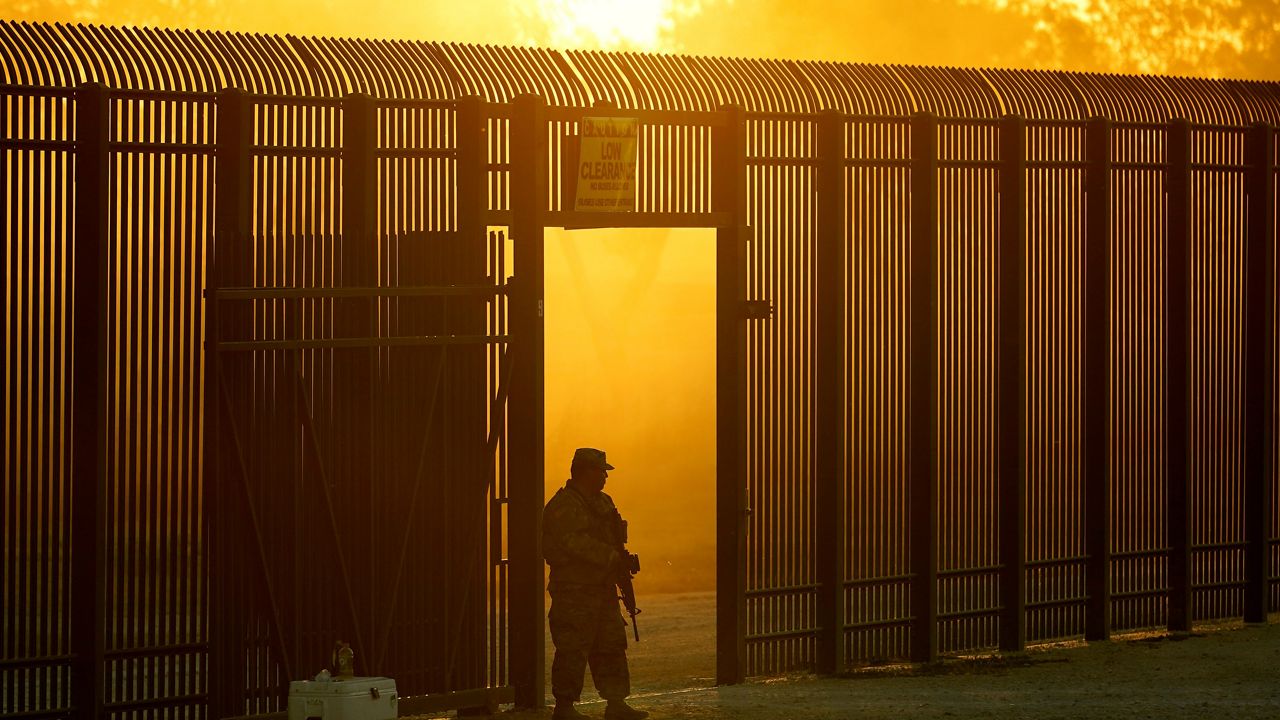 A National Guardsman stands guard at a fence that runs along the Rio Grande near the International bridge in Del Rio, Texas, Sept. 17, 2021. A year into the Joe Biden’s presidency, though, action on the immigration system has been hard to find and there is growing consternation privately among some in the party that the Biden administration can’t find the right balance on immigration. (AP Photo/Eric Gay, File)