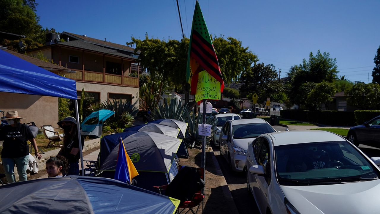 A tent encampment set up by protesters demanding a resignation from Los Angeles City Councilmember Kevin de Leon is seen near his home in Los Angeles, Tuesday, Oct. 18, 2022. (AP Photo/Jae C. Hong)