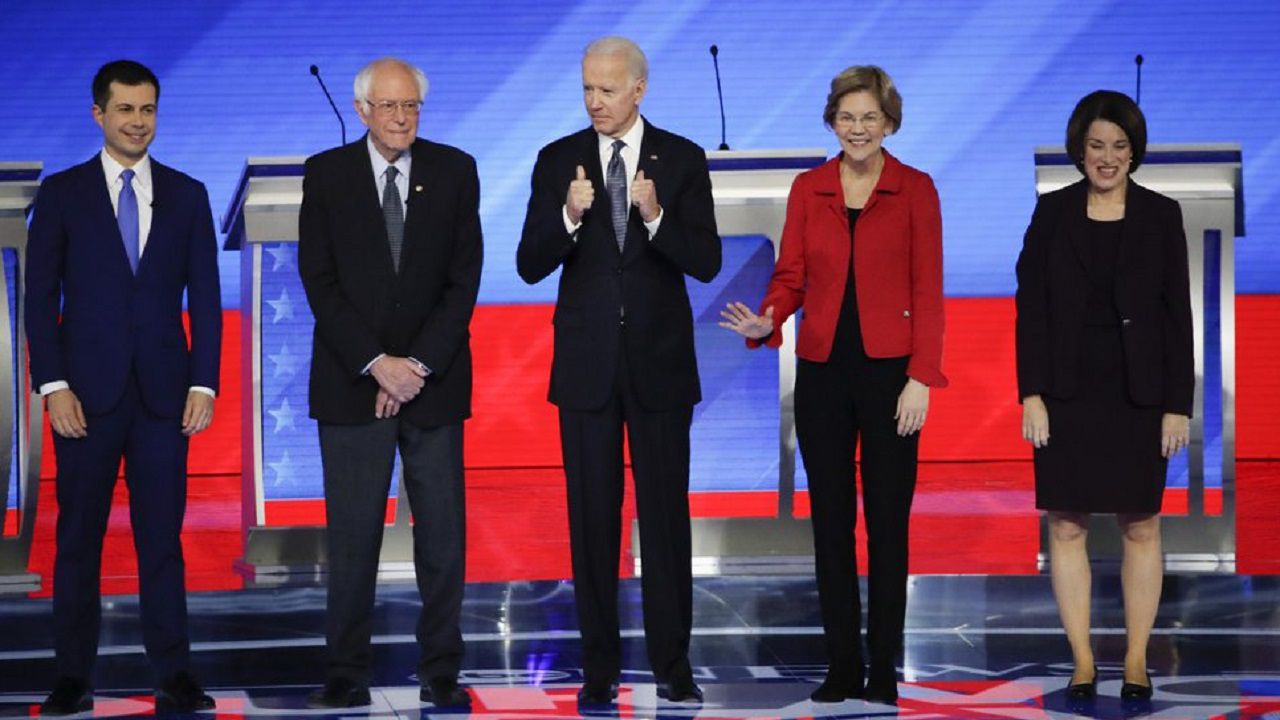 Five Democratic candidates on the stage in New Hampshire. A new candidate will join them on Wednesday: Mike Bloomberg. (File/AP)