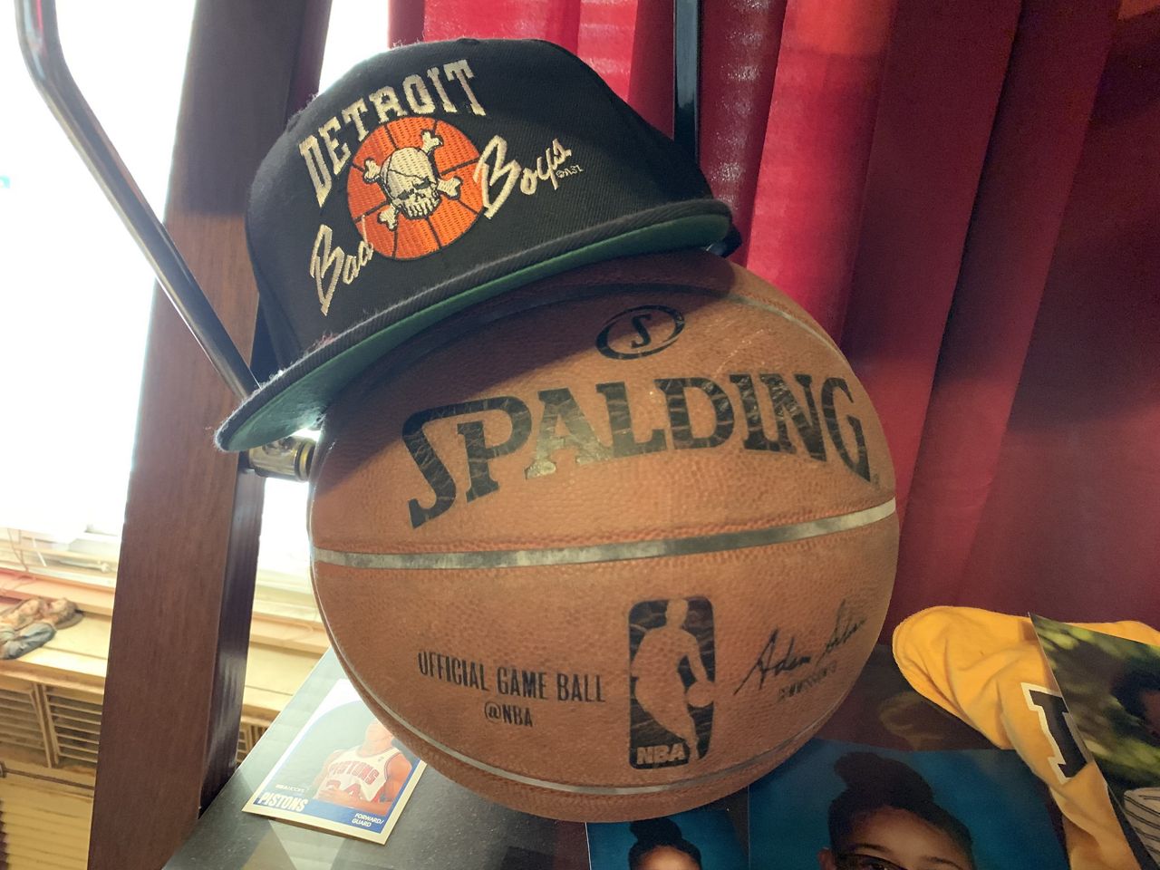 A hat belonging to Fennis Dembo from his time in Detroit during the Pistons' "Bad Boys" era sits atop a basketball. (Spectrum News 1/Adam Rossow)