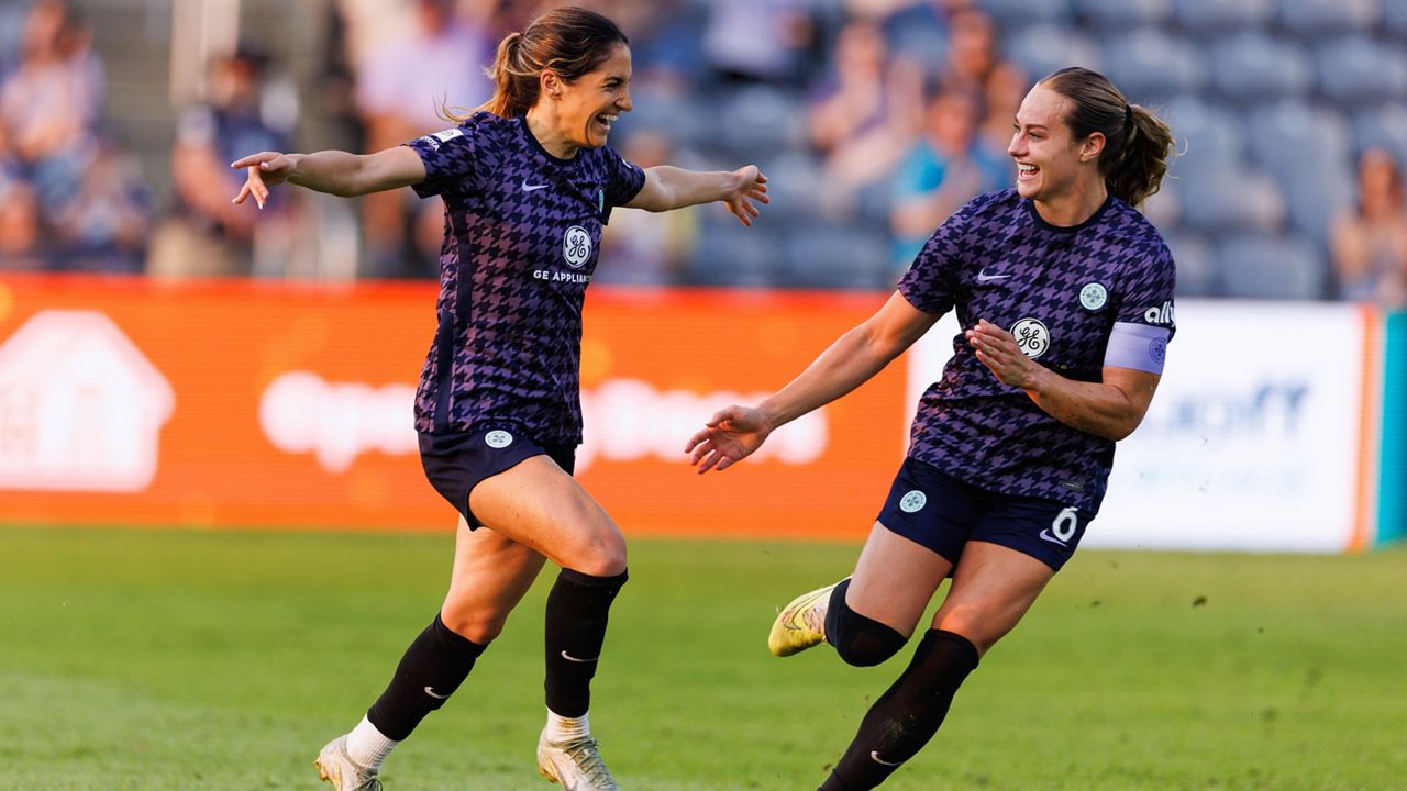 racing louisville midfielders celebrating a goal