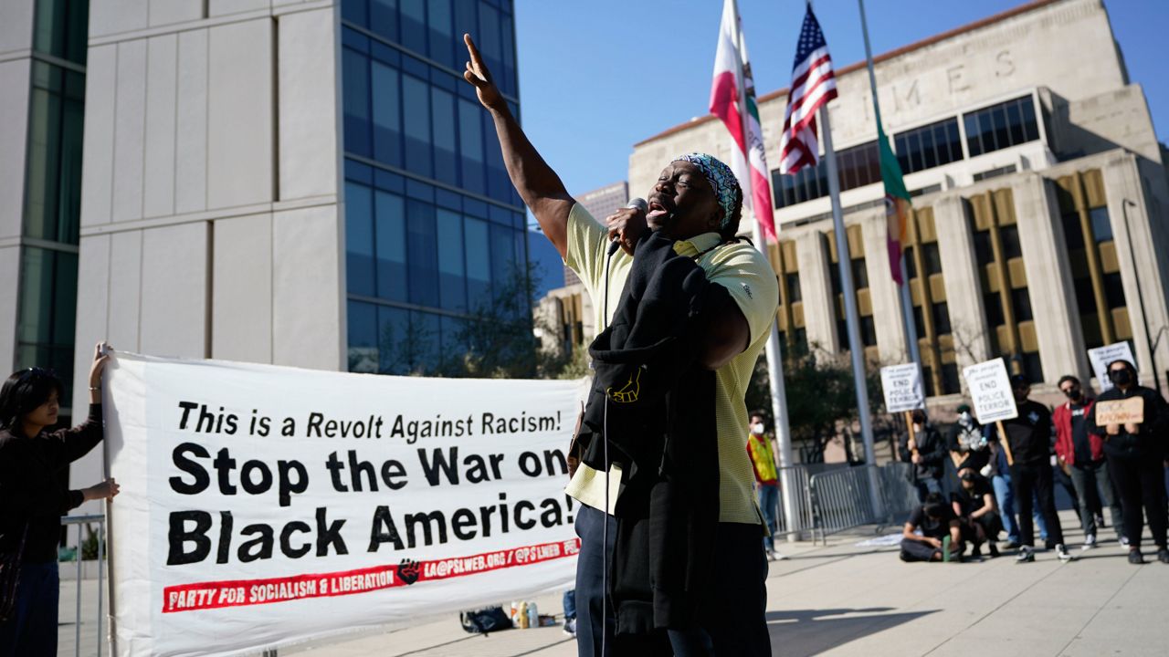 Pastor Stephen Jn-Marie speaks to a crowd of demonstrators Saturday, Jan. 28, 2023, outside of the LAPD headquarters in Los Angeles during a protest over the death of Tyre Nichols, who died after being beaten by Memphis, Tenn., police. (AP Photo/Marcio Jose Sanchez)