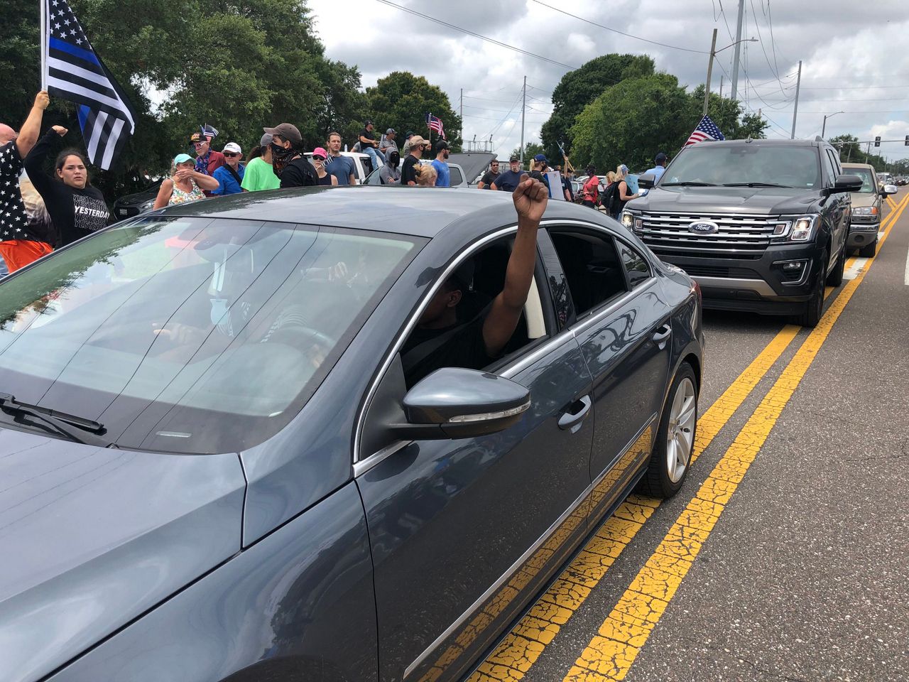 Drivers in their cars show support for Black Lives Matter as they drive past a "Back the Blue" rally in Tampa, Saturday, June 13, 2020. (Ashley Paul/Spectrum Bay News 9)