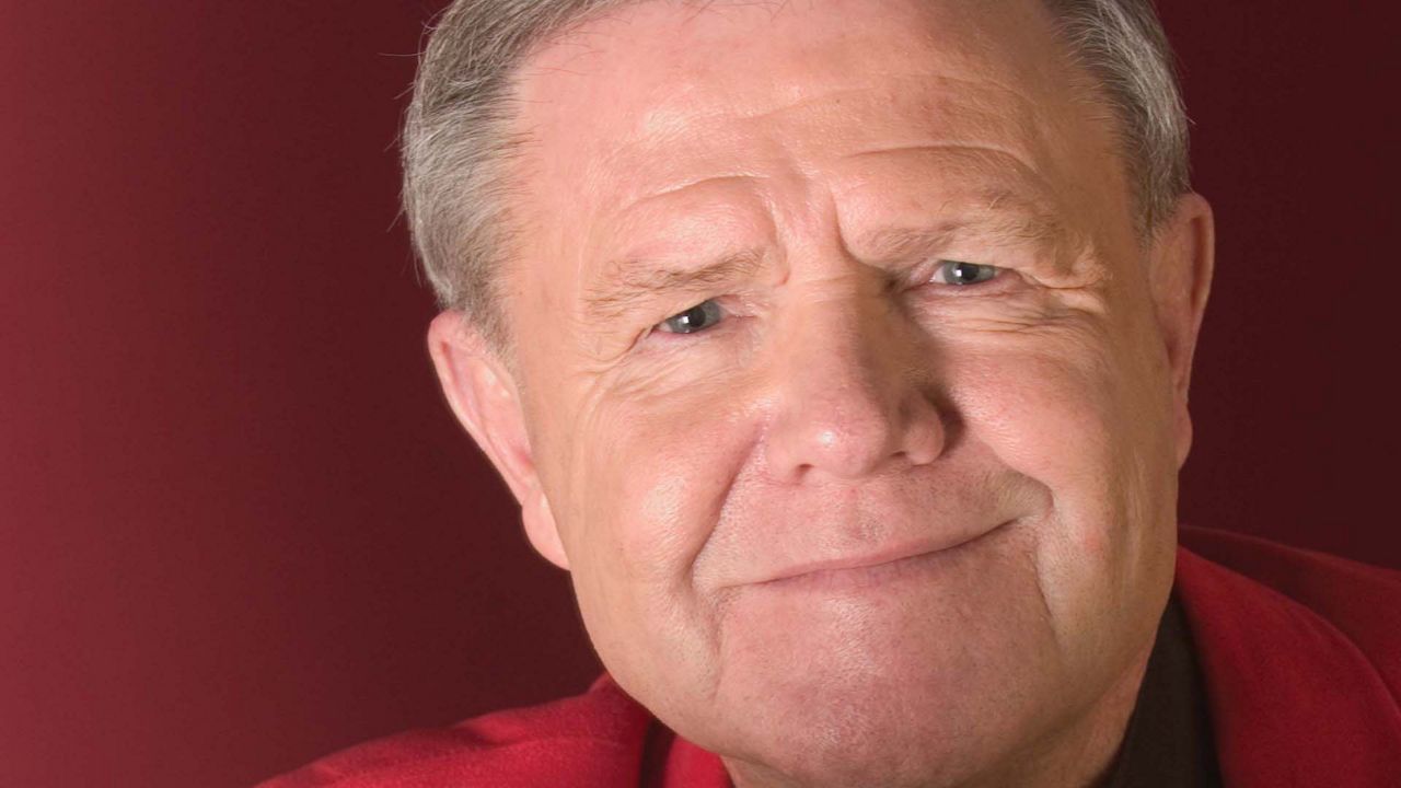 Former U of L coach Denny Crum shows off his sports collection