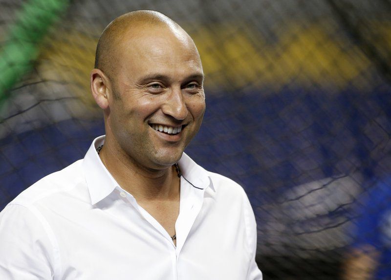 Miami Marlins CEO Derek Jeter smiles as he watches batting practice before a baseball game against the Los Angeles Dodgers, Wednesday, May 16, 2018, in Miami. (AP Photo/Wilfredo Lee)