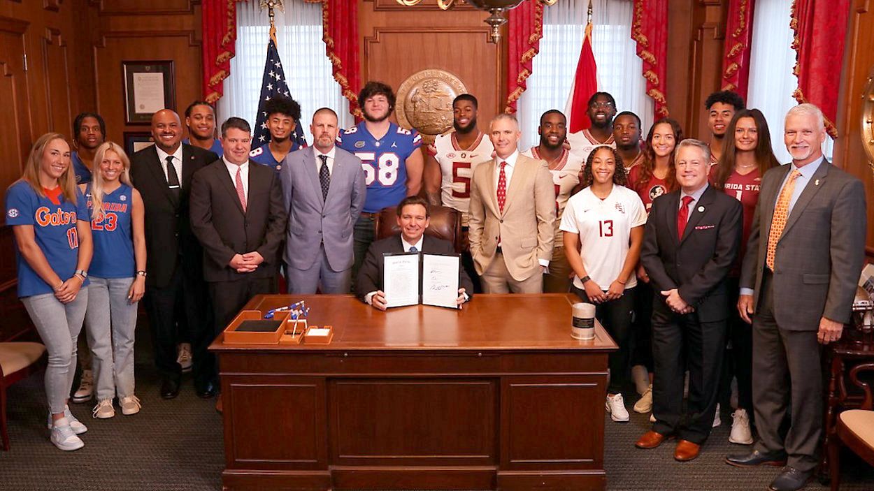 Florida Governor Ron DeSantis displays a bill he signed into law Thursday that allows student-athletes more control of their identity. (Picture courtesy of the Office of the Governor)