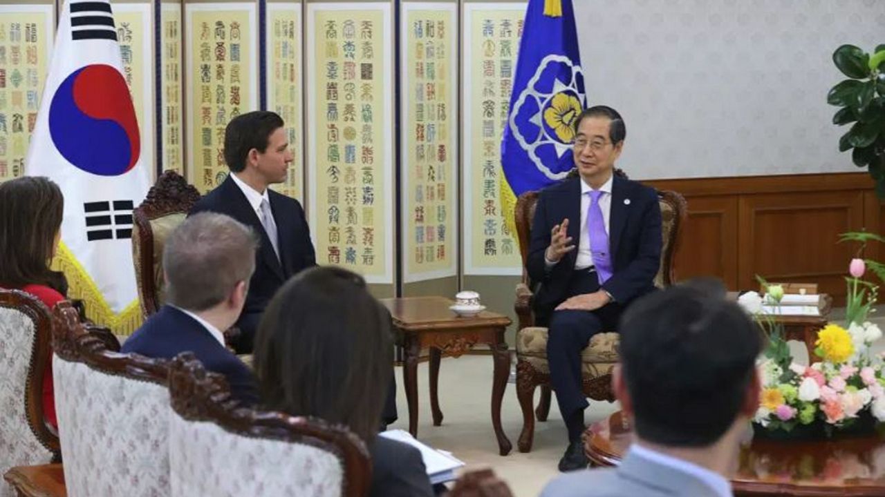 South Korean Prime Minister Han Duck-soo (right) talks with Florida Gov. Ron DeSantis during a meeting at the government complex in Seoul.  (South Korean Prime Minister Office via AP)