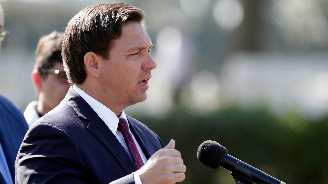 Florida Gov. Ron DeSantis delivers remarks during a press conference at a coronavirus mobile testing site Monday, March 23, 2020, in The Villages, Fla. The Villages, a retirement community, is one of the largest concentration of seniors in the U.S. (AP Photo/John Raoux)
