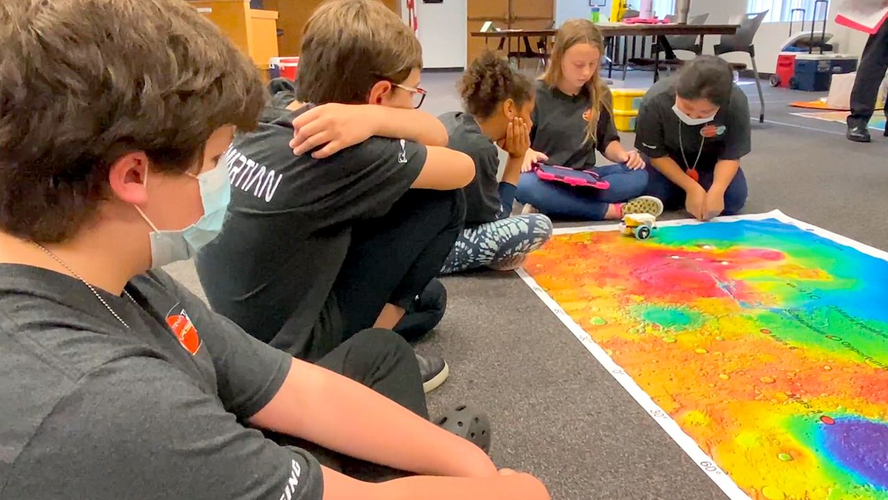 Brevard County students go over a topographical map of Mars as part of the Brevard Schools Foundation's Destination Mars design challenge. (Spectrum News 13/Greg Pallone)