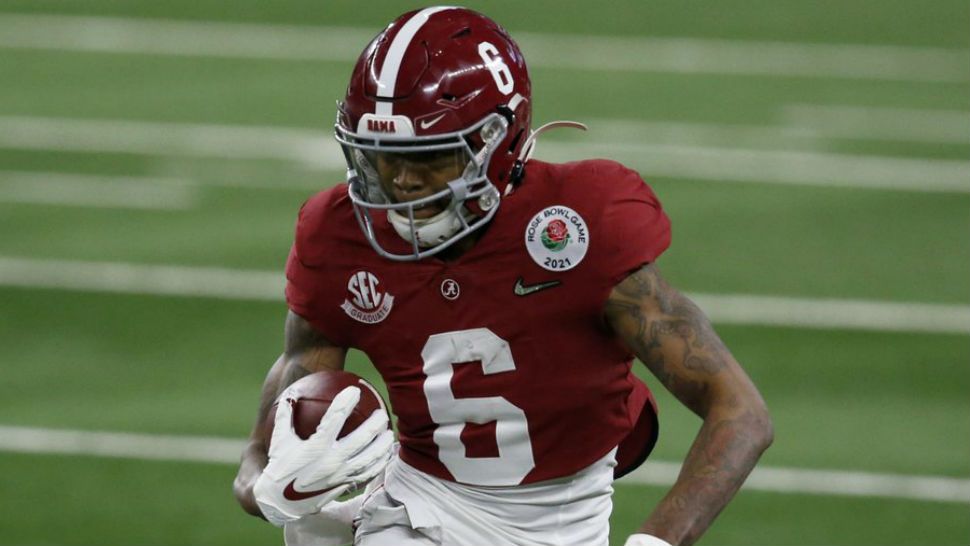 Alabama wide receiver DeVonta Smith (6) gains yardage after a catch in the first half of the Rose Bowl NCAA college football game against Notre Dame in Arlington, Texas, Friday, Jan. 1, 2021. (AP Photo/Roger Steinman)