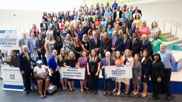 Ohio Gov. Mike DeWine, RecoveryOhio Director Aimee Shadwick and Hamilton County officials and business leaders pose for a photo at the Cincinnati & Hamilton County Public Library.