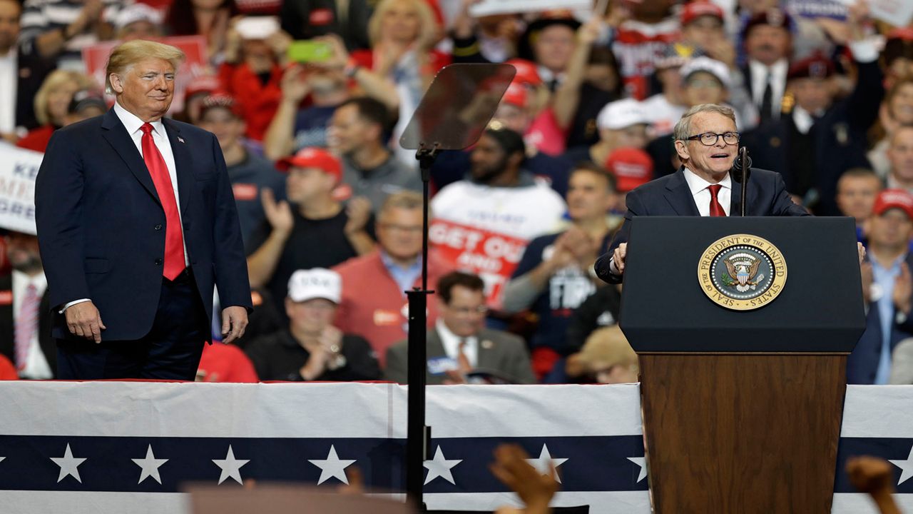  President Donald Trump listens as Ohio gubernatorial candidate Mike DeWine speaks at a campaign rally on Nov. 5, 2018, in Cleveland. According to a statement Wednesday, Sept. 7, 2022, former President Donald Trump has endorsed DeWine in his reelection bid after deciding against openly backing him in the primary. (AP Photo/Tony Dejak)
