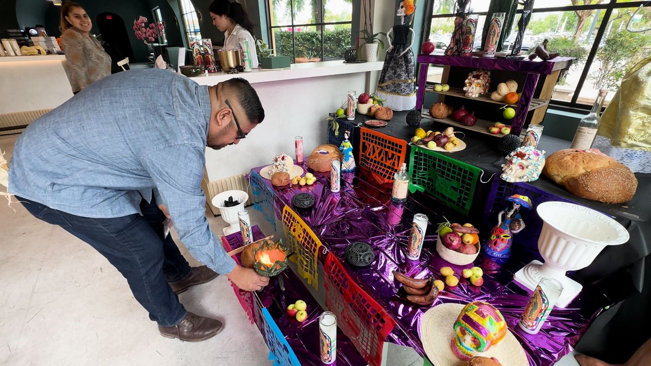 Ivan Vasquez prepares his altar inside his restaurant, Madre!, in Santa Clarita.