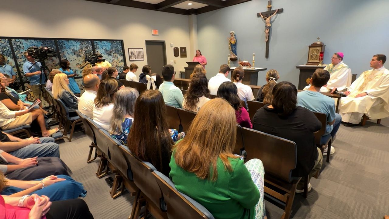Bishop Gregory Parkes leads mass for a small group who gathered in the Chapel at St. Petersburg Catholic High School to celebrate. (Spectrum News/Fallon Silcox)