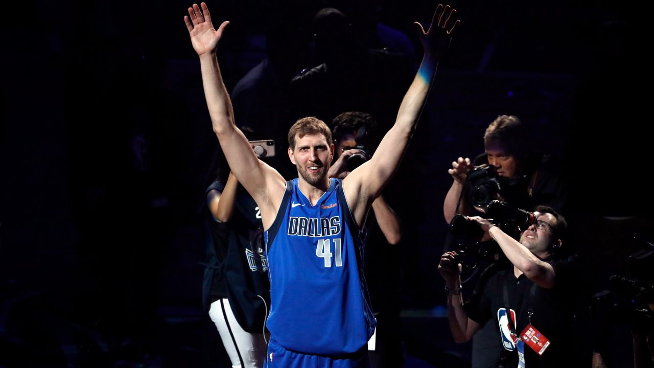 Dallas Mavericks' Dirk Nowitzki acknowledges cheers from fans as he walks off the court following the team's NBA basketball game against the Phoenix Suns in Dallas, Tuesday, April 9, 2019. The Dallas Mavericks are retiring Dirk Nowitzki's No. 41 when Stephen Curry and the Golden State Warriors visit in January. (AP Photo/Tony Gutierrez, File)