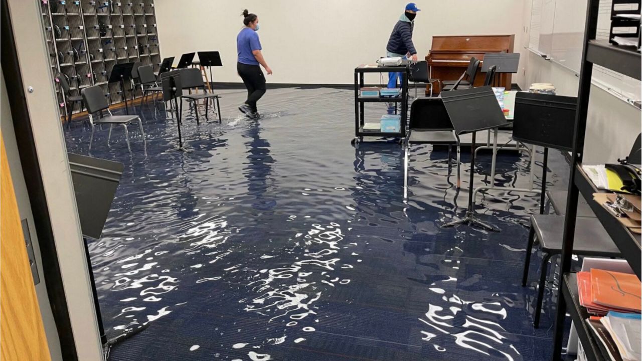 Maintenance crews work to remove water in E.D. Walker Middle School’s band room brought on by flooding due to the winter storm. (Photo Source: Dallas ISD)