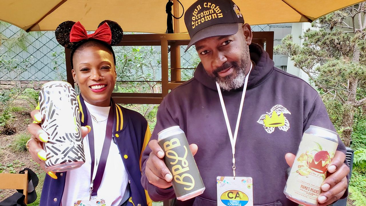 Crowns and Hops co-founders Beny Ashburn, left, and Teo Hunter at Disney's Grand Californian Hotel & Spa showcasing their craft beers (Spectrum News/Joseph Pimentel)